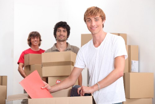 Moving team unloading household items at a Brompton property