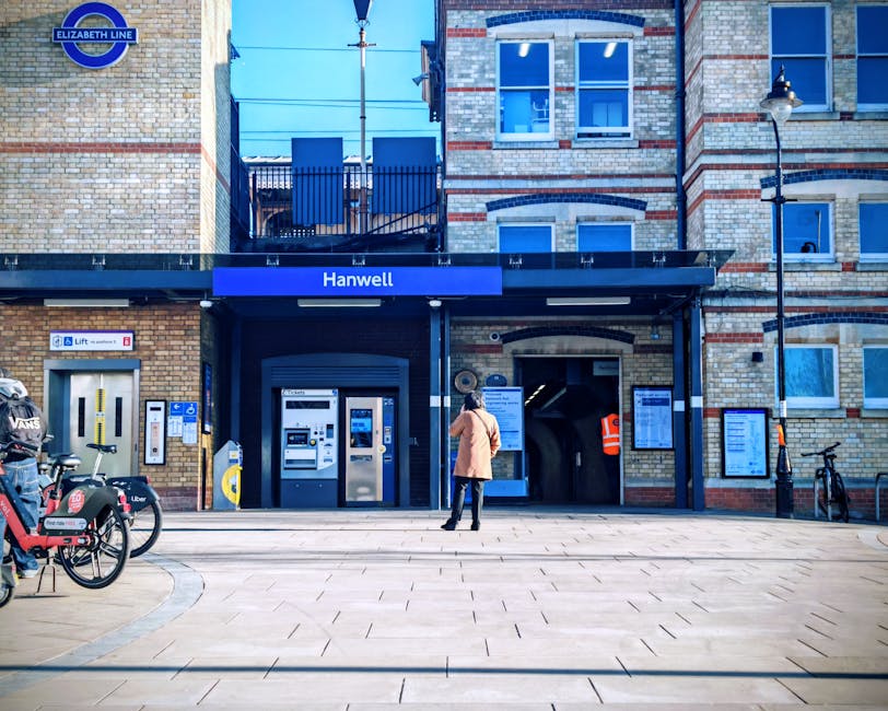 The image displays a scene of a home relocation or furniture transport process outside a residential property, possibly near West Brompton station. In the foreground, a large cardboard box is position